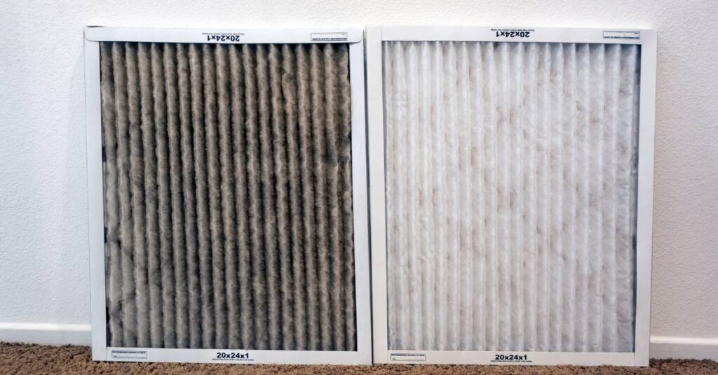 A clean HVAC air filter is shown beside a filthy one on a brown carpet while leaning against a white wall.
